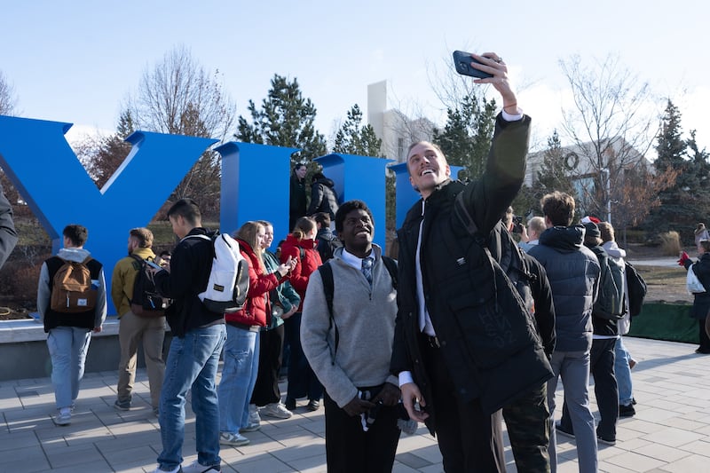 BYU-Idaho students take selfies with the new block-letter BYUI monument unveiled on campus on Dec. 10, 2024.