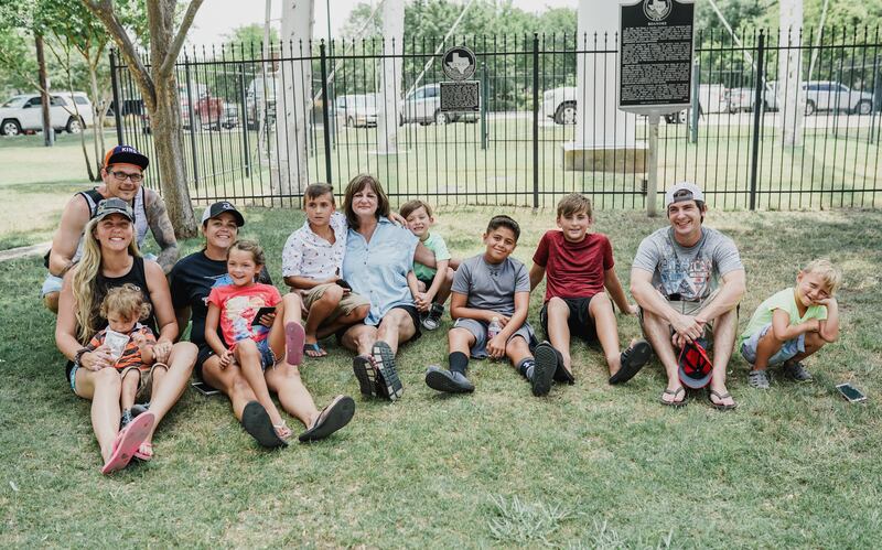 Erica and Josh Hartwig, left, and Erica's in-laws from her previous marriage take a break in Dallas after playing Pokemon Go with the kids. The Hartwigs often vacation with her former in-laws.