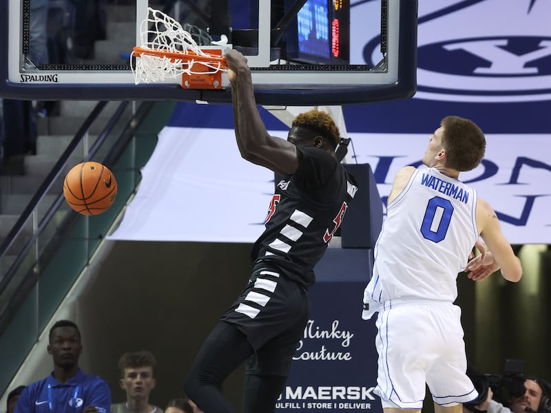 Cincinnati Bearcats forward Aziz Bandaogo (55) dunks over Brigham Young Cougars forward Noah Waterman (0) in Provo on Saturday, Jan. 6, 2024. Cincinnati won 71-60.