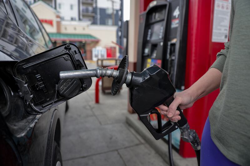Whitley Davis pumps gas into her car at a Maverik in Salt Lake City on Monday, April 11, 2022.