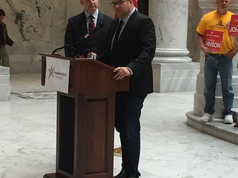 Republican Jonathan Johnson, left, listens FreedomWorks president and CEO Adam Brandon endorses him for governor at the state Capitol on Tuesday, May 24, 2016.