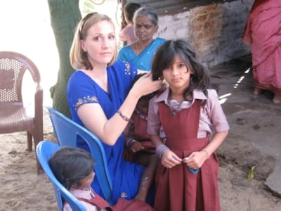 Amy Antonelli braids a young girl's hair in India in 2008. Antonelli served as the first executive director of Rising Star Outreach, a nonprofit devoted to helping leprosy colonies in India.