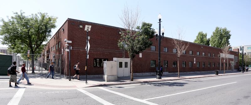 People walk past the Road Home in Salt Lake City on Wednesday, Aug. 8, 2018.
