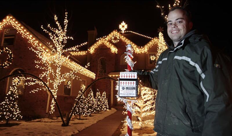 Richard Holdman shows off some of the 45,000 lights in front of his Pleasant Grove home. While decorating, he listened to several books on tape.