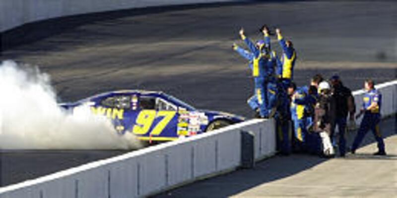 Kurt Busch is greeted by his teammates after winning NASCAR's first Chase for the Championship race.