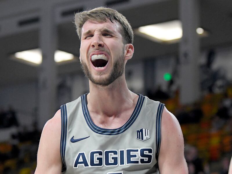  Utah State forward Brandon Horvath, wearing grey, celebrates