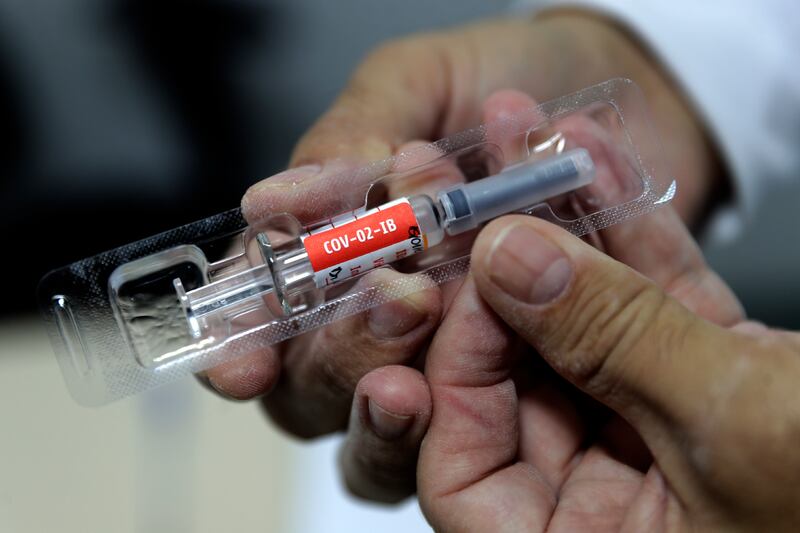 A health worker shows a dose of China’s Sinovac Biotech experimental vaccine for the new coronavirus during the testing stage at the University Hospital of Brasilia, Brazil, Friday, Jan. 15, 2021. A research team from the University Hospital is carrying out tests since June 2020 and now started tests on elderly health professionals over 60 years old.