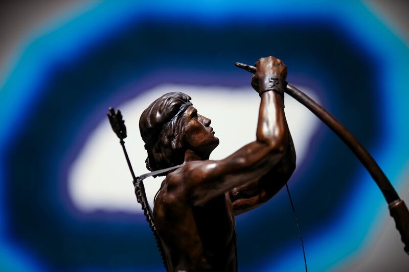 A detail of "Never a Murmur," a cast bronze sculpture by Craig Cunningham, is pictured in front of "Lights of Night," an acrylic piece by Roland Thompson, during a media preview for the 11th International Art Exhibition at the Church History Museum in Sal