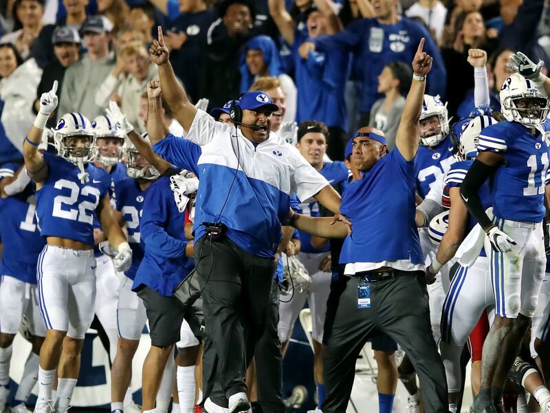 BYU head coach Kalani Sitake and the rest of the BYU sideline begin to celebrate victory over Utah at LaVell Edwards Stadium.