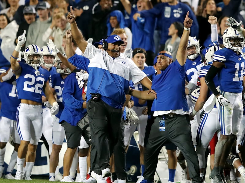 BYU head coach Kalani Sitake and the rest of the BYU sideline begin to celebrate victory over Utah at LaVell Edwards Stadium.
