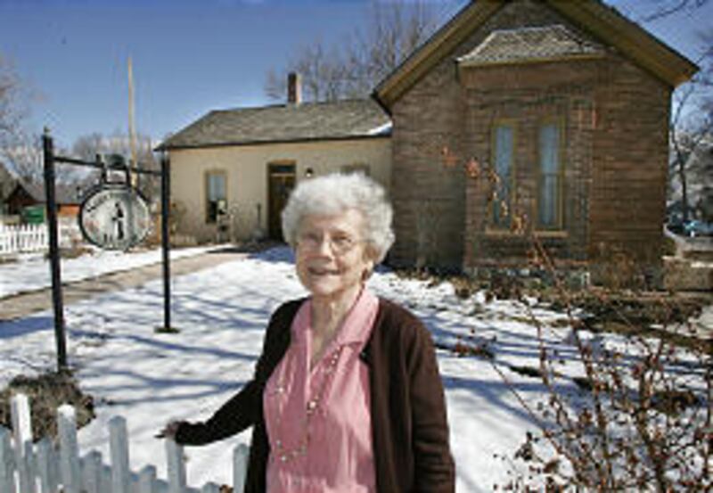 Velora Sorensen Whetman stands by the house she grew up in. It's now the Sorensen Home Museum.