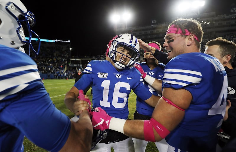 BYU Cougars quarterback Baylor Romney is congratulated by teammates following their defeat of the Boise State in 2019.