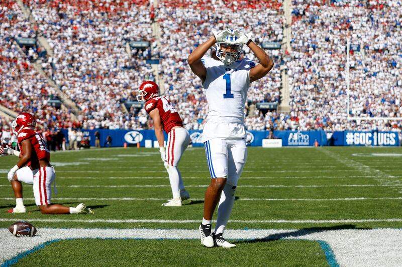 BYU’s Keanu Hill makes a heart for fans after scoring a touchdown against the Arkansas Razorbacks, Oct. 15, 2022.