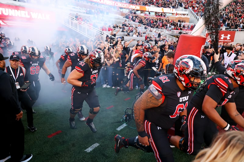 Utah players run out onto the field as they prepare to play USC at Rice-Eccles Stadium in Salt Lake CIty on Saturday, Oct. 15, 2022.