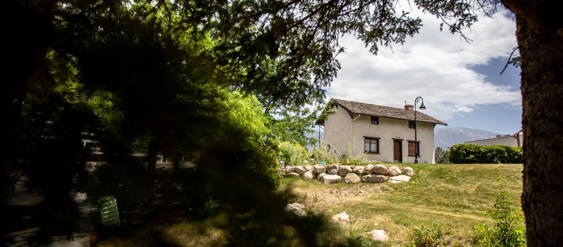The replica Cox home sits on a small patch of grass in the parking lot of the Babies ‘R Us store in Midvale, Utah.