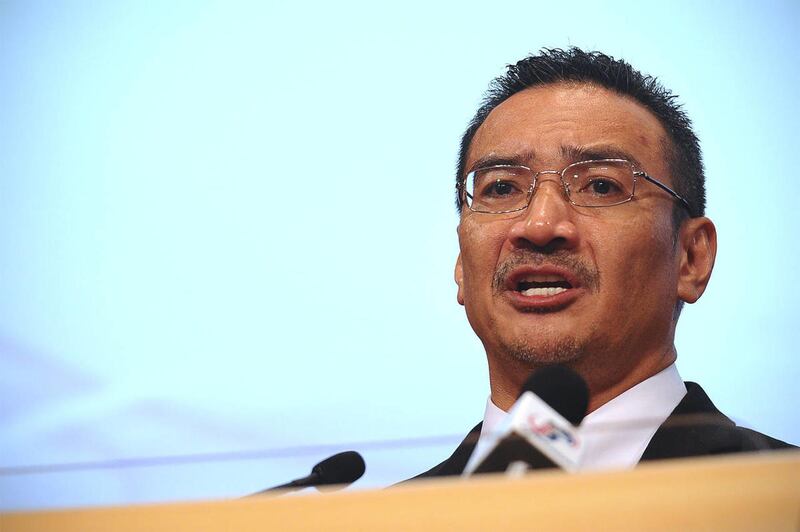 Malaysia's acting Transport Minister Hishammuddin Hussein answers queries from a journalist during a press conference for the missing Malaysia Airlines flight MH370 at Putra World Trade Center (PWTC) in Kuala Lumpur, Malaysia, Monday, March 24, 2014. Chin