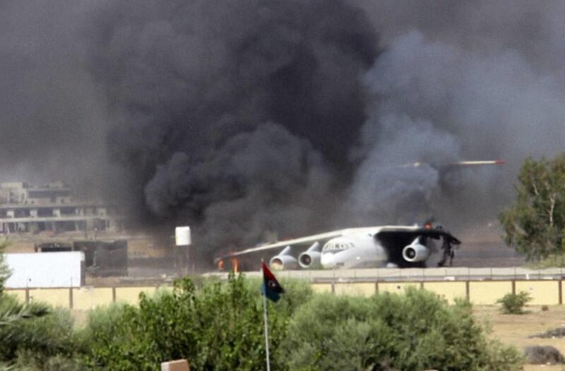In this Saturday, July 26, 2014 frame grab from video obtained from a freelance journalist traveling with the Misarata brigade, shows an airplane on the tarmac of the airport belching black smoke into the air during fighting between the Islamist Misarata
