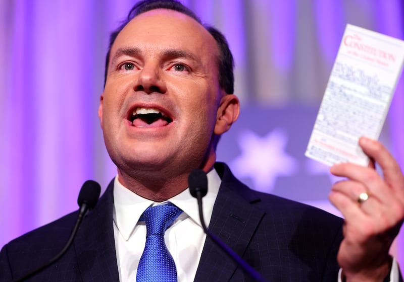 Sen. Mike Lee holds his pocket copy of the Constitution as he speaks to a crowd of supporters.