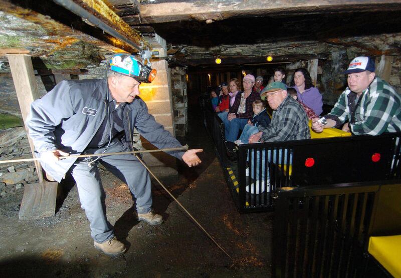 FILE - In a March 31, 2006 file photo, Beckley Exhibition Coal Mine tour guide and retired coal miner George Archibald demonstrates a tamping rod in Beckley, W.Va. during an underground tour. Doug Estepp, a Mingo County native, has launched a company tha