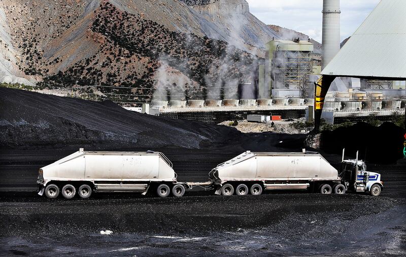 A truck dumps coal at the Huntington power plant in Huntington onMarch 24, 2015.