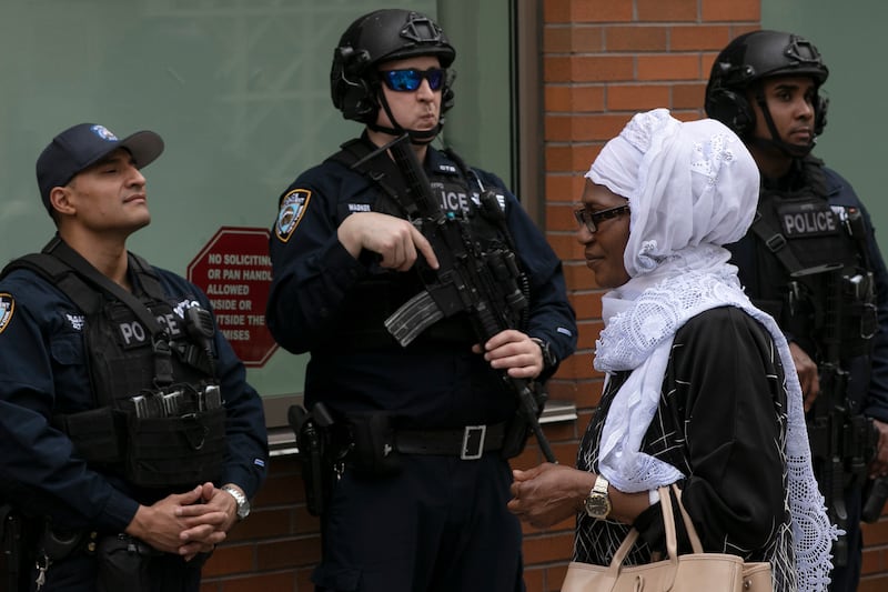 A woman leaves the Islamic Cultural Center of New York under increased police security following the shooting in New Zealand, Friday, March 15, 2019, in New York.