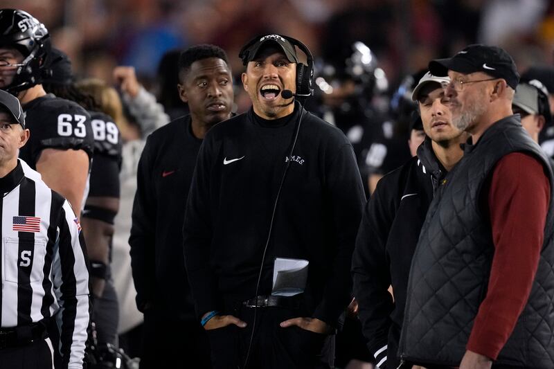 Iowa State head coach Matt Campbell, center, reacts as he watches a replay on the video board during game against Kansas.