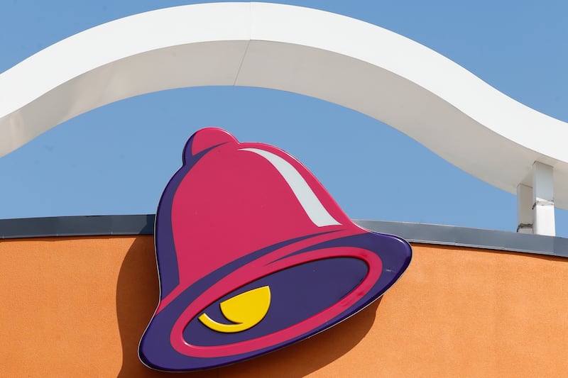 This July 30, 2019, file photo shows a sign outside a Taco Bell restaurant in Conyers, Georgia. After a sales boom during the pandemic, Yum! Brands, the parent company of Taco Bell, is looking to make mobile ordering even easier.