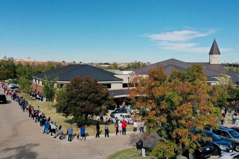In this Friday, Oct. 30, 2020 file photo, the line for early voting at a polling place in Oklahoma County wraps around Edmond Church of Christ in Edmond, Okla.