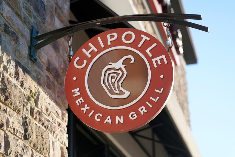 The Chipotle Mexican Grill logo hangs outside a restaurant location.