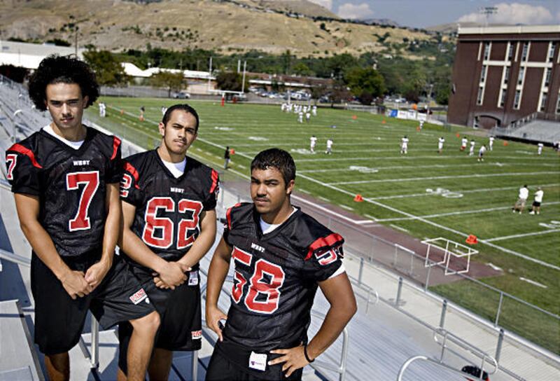 West High School football players Tevita Fangupo, left, Sione Talakai and Tay Scott have a lot more on their plates than just playing football.