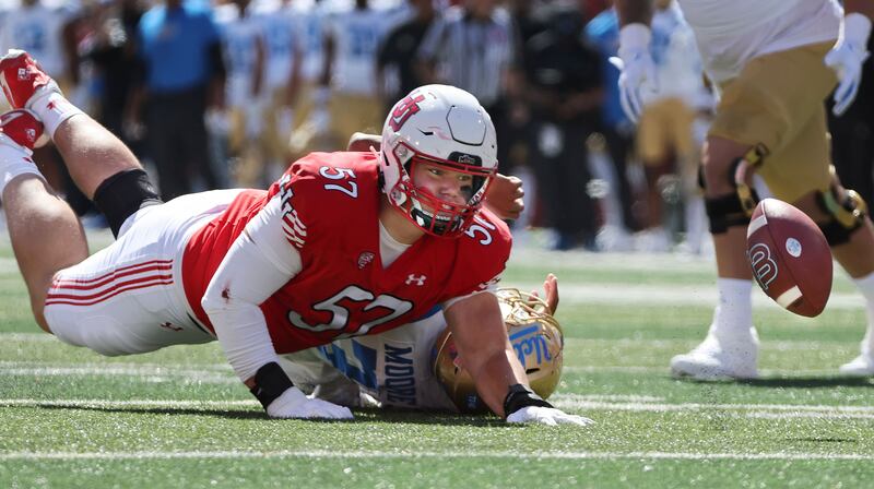 Utah Utes defensive tackle Keanu Tanuvasa (57) sacks UCLA Bruins quarterback Dante Moore (3) causing a fumble in Salt Lake City on Saturday, Sept. 23, 2023.