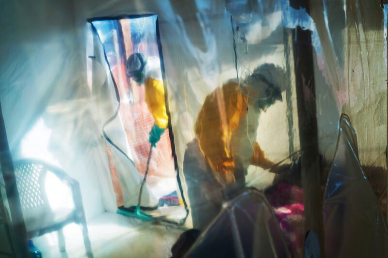 In this Saturday, July 13, 2019 file photo, health workers wearing protective suits tend to an Ebola victim kept in an isolation tent in Beni, Democratic Republic of Congo.