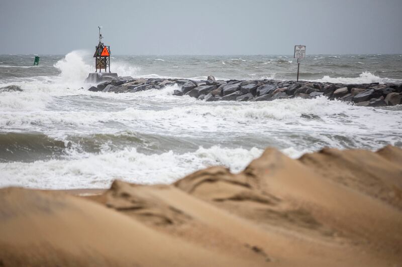Waves break along the jetty at Rudee Inlet in Virginia Beach, Va., as Tropical Storm Ophelia approaches the area.