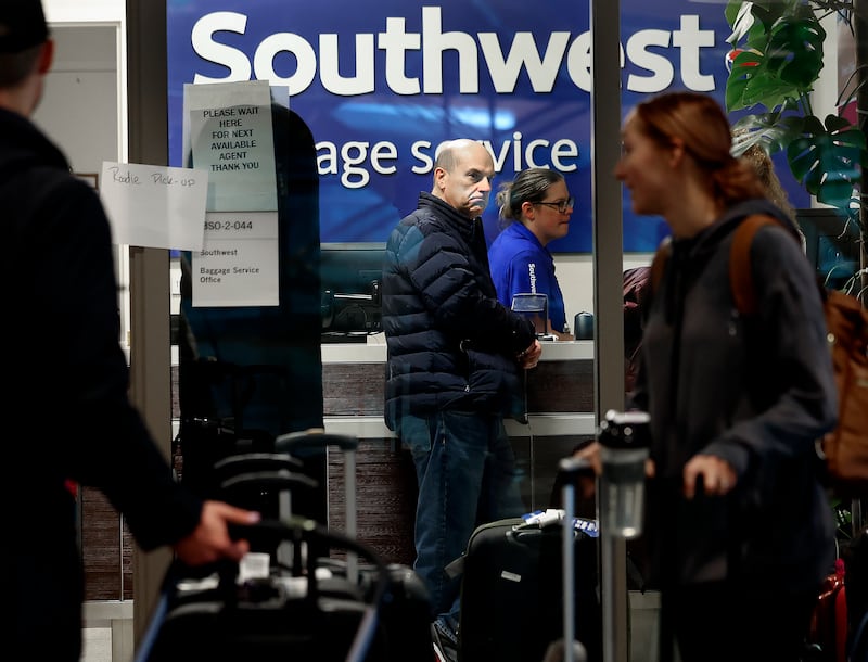 Customers gather at the Southwest Airlines customer service office at Salt Lake City International Airport on Dec. 30, 2022.