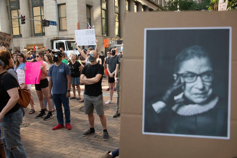 A sign depicting the late Supreme Court Justice Ruth Bader Ginsburg is held up at a pro-abortion protest.