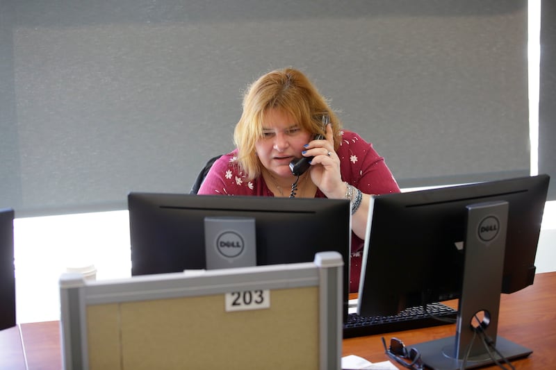 Carolyn Smigla, who has been volunteering at the National Runaway Safeline for 5 years takes a phone call, Friday, March 23, 2018 in Chicago, Illinois. Smigla helps youth, teens, parents and guardians seeking help with runaway victims or victims who are t