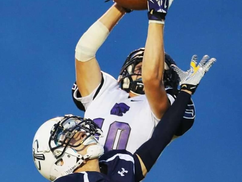 Lehi's Austin Whetzel makes an interception in the end zone over West lake's Robert Santiago as West Lake and Lehi play Friday, Sept. 13, 2013 at West Lake.