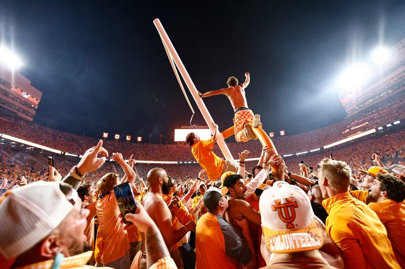 Tennessee fans tear down the goal post after defeating Alabama 52-49 in a football game Oct. 15, 2022, in Knoxville, Tenn.
