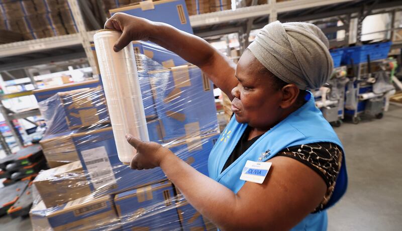Olivia Sserabira, from Uganda, works at Walmart in Salt Lake City shipping packages out to customers on May 19.