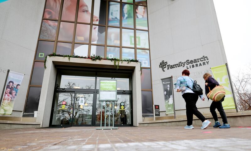 Two women walk toward the FamilySearch Center.