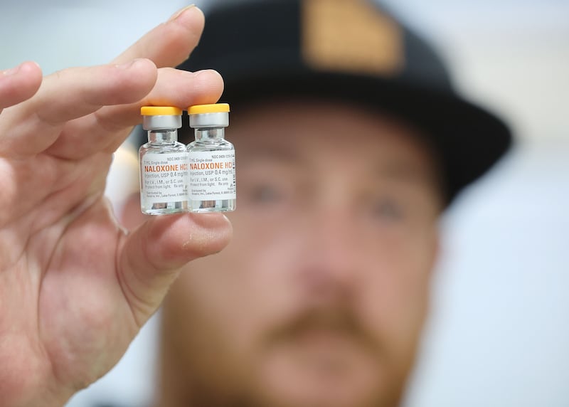 Riley Drage, a Utah Naloxone trainer, holds a naloxone vial prior to training for opioid overdose in Salt Lake City.