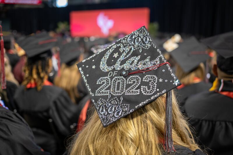 A University of Phoenix graduate looks out over the crowd during the April 29, 2023, commencement in Glendale, Ariz.