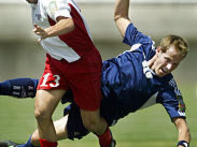 Utah Blitzz's Alejandro Gutierrez-Mendez fouls BYU's Brock Blake in the first half of Saturday's game at Rice-Eccles Stadium.