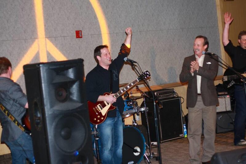 Dan Musgrave introduces the Greg Simpson Band at a celebration following the screening of "The Music Never Stopped" at the Sundance Film Festival.