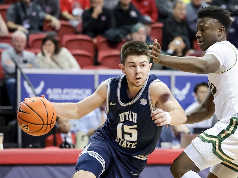 Utah State Aggies guard Rylan Jones (15) drives around Colorado State Rams guard Isaiah Stevens (4) during a Mountain West tournament quarterfinal at the Thomas & Mack Center in Las Vegas on Thursday, March 10, 2022.