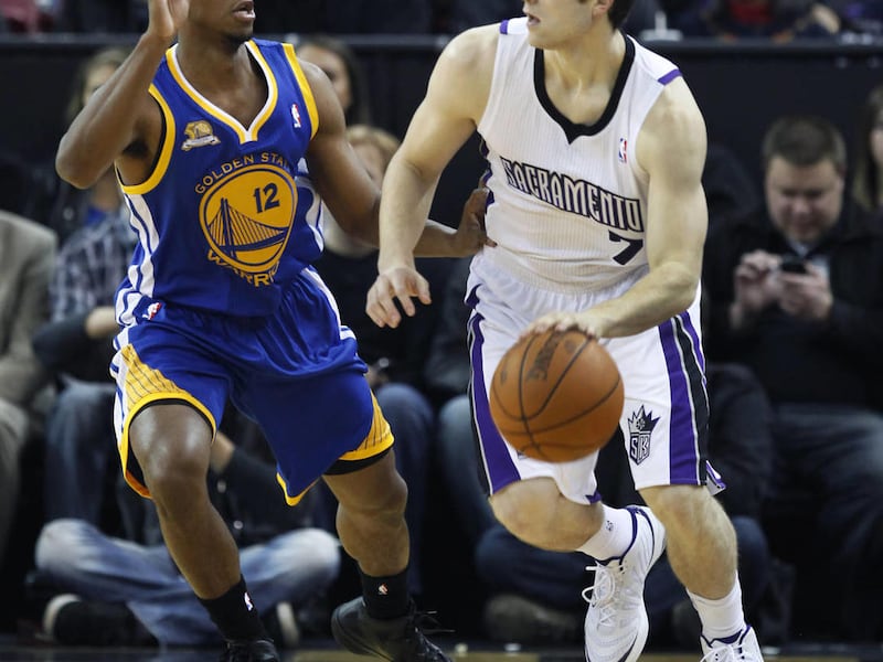 Golden State Warriors guard Ish Smith, left, defends against Sacramento Kings guard Jimmer Fredette during the first half of an NBA preseason basketball game in Sacramento, Calif., Tuesday, Dec., 20, 2011.