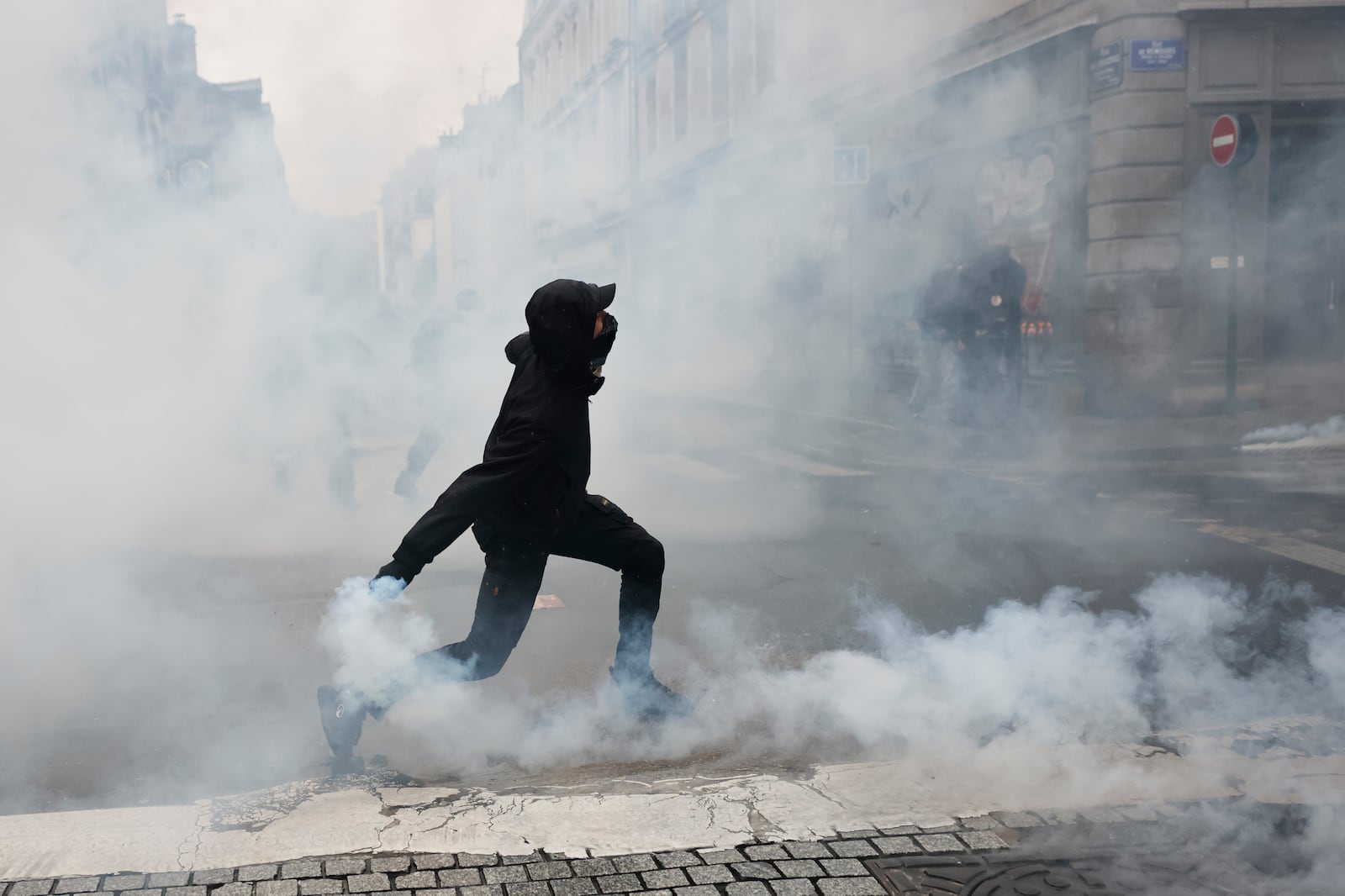 A protester throws a teargas canister to police after a demonstration against rising living costs in Rennes, France, Saturday, Oct. 24, 2026. | Jeremias Gonzalez, Associated Press