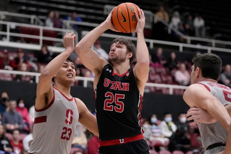 Utah guard Rollie Worster (25) shoots against Stanford forward Brandon Angel (23) during the first half of an NCAA college basketball game in Stanford, Calif., Saturday, Dec. 31, 2022.