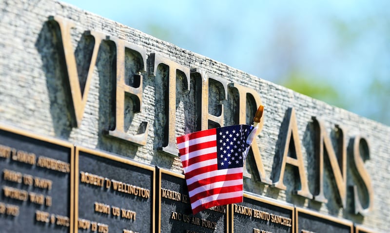 A small American flag waves in the wind after bering placed on the veterans memorial at the Memorial Redwood Mortuary and Cemetery on May 24, 2020.