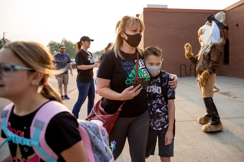 Kim Tafoya walks with her son, Dillon, who is entering fifth grade, before the first day of school at Altara Elementary in Sandy.
